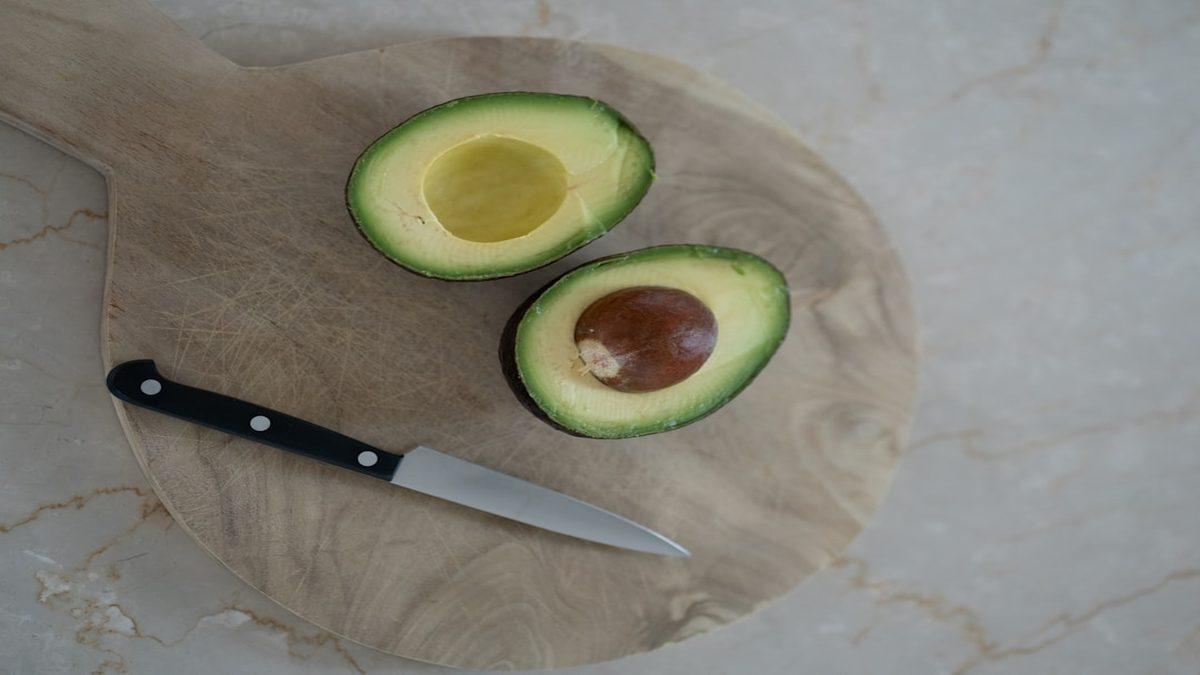 easy plant based breakfast — avocado toast with seeds on wooden board