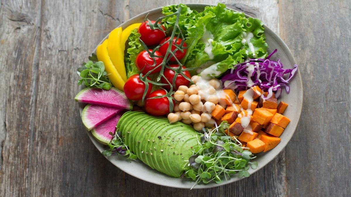 eating more plants — colorful vegetable bowl on wooden table