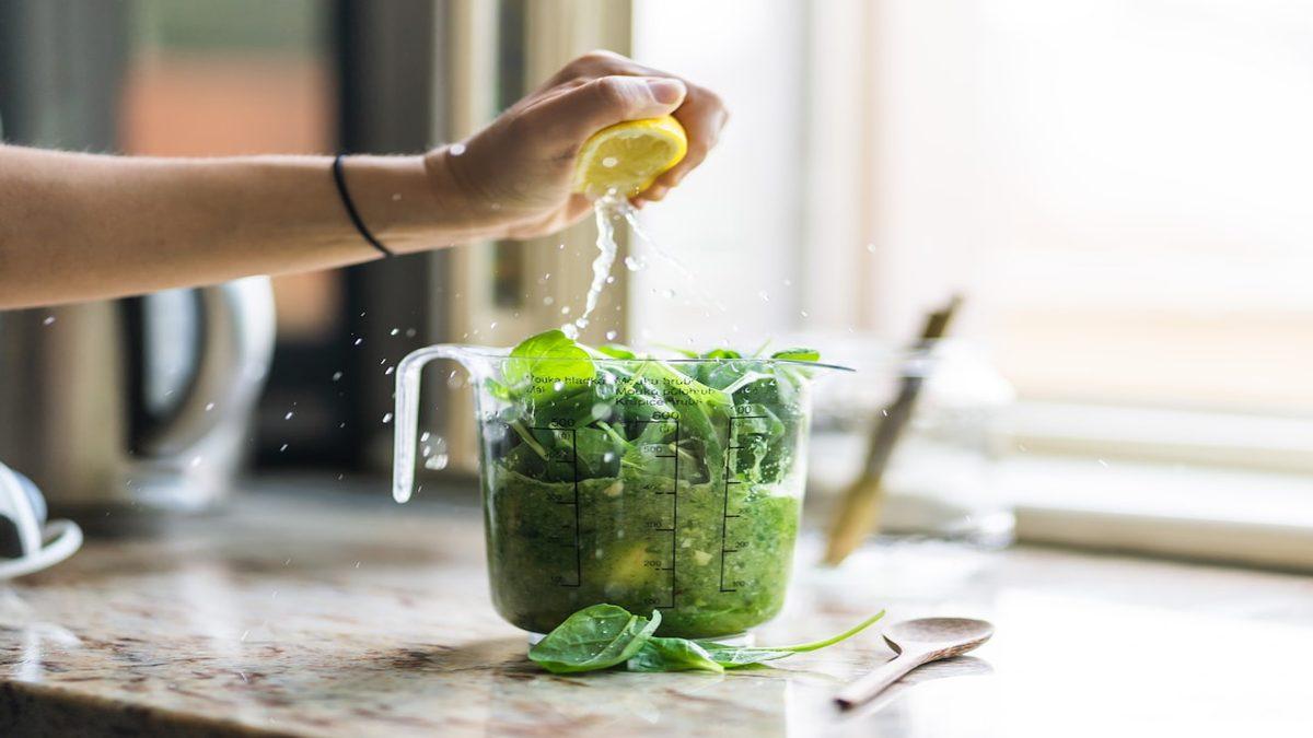 fiber needs whole foods — vibrant leafy greens on wooden board