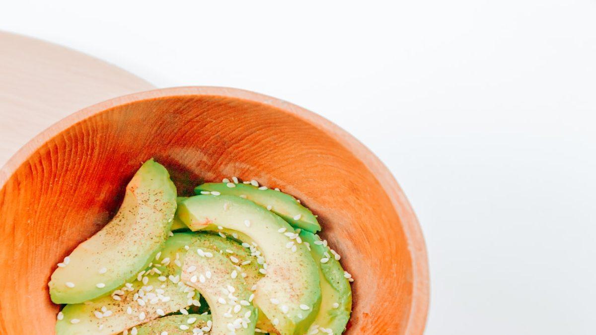 nutrient dense foods for small appetites — avocado toast topped with seeds on rustic wooden plate
