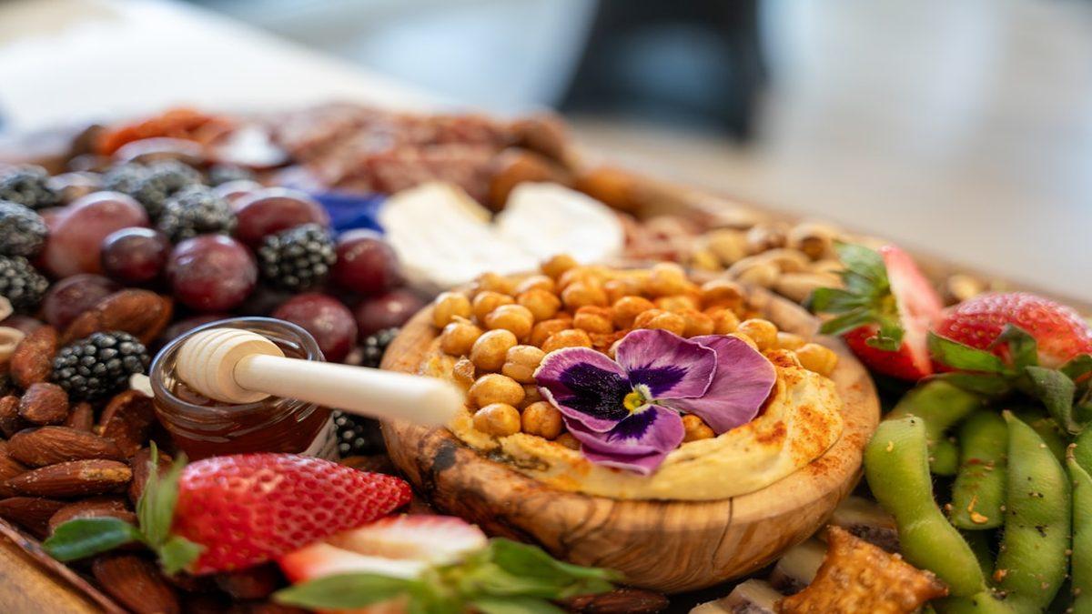 plant-based protein sources — chickpeas and fresh vegetables on wooden board