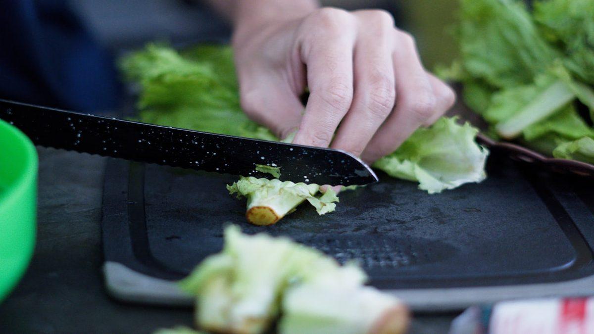 plant-based swaps for heart health — fresh leafy greens on wooden cutting board