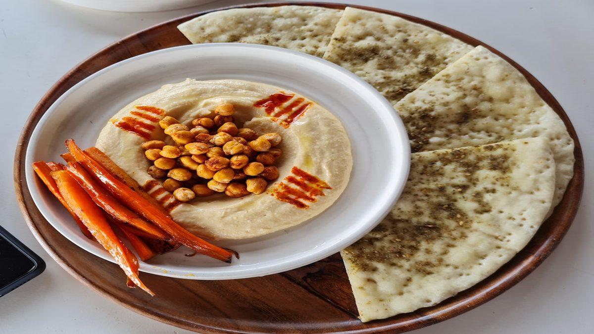 plant-forward protein — creamy chickpea hummus with sesame seeds