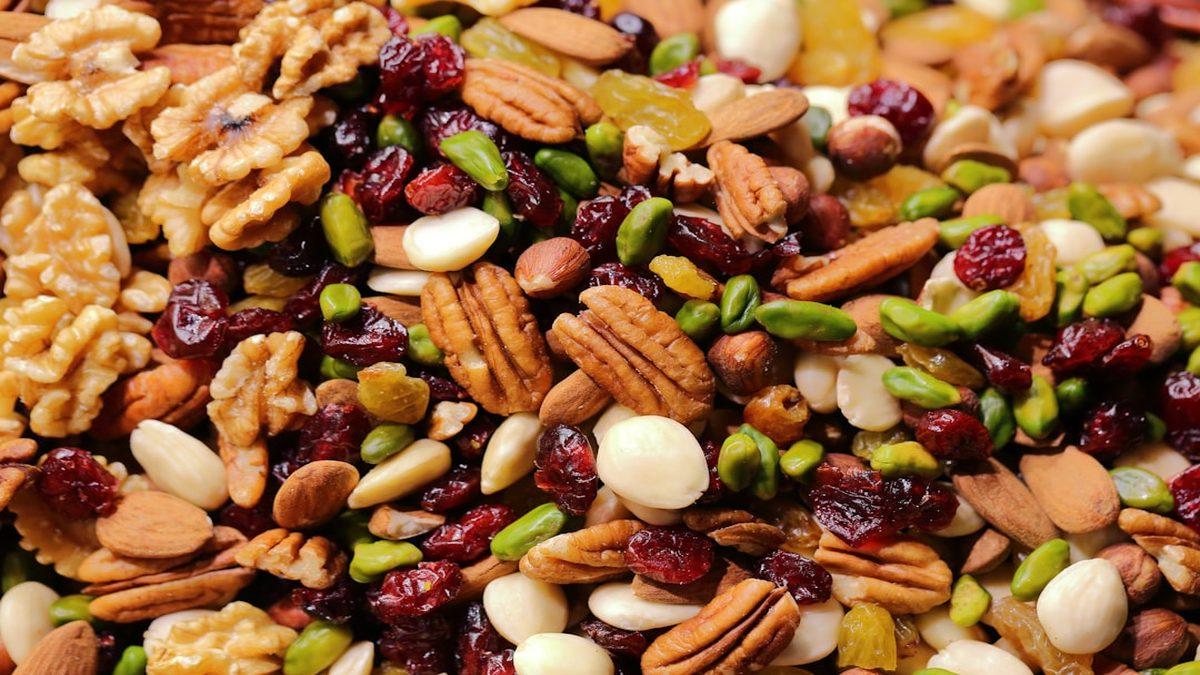 whole foods vs processed protein — fresh nuts and seeds arranged naturally