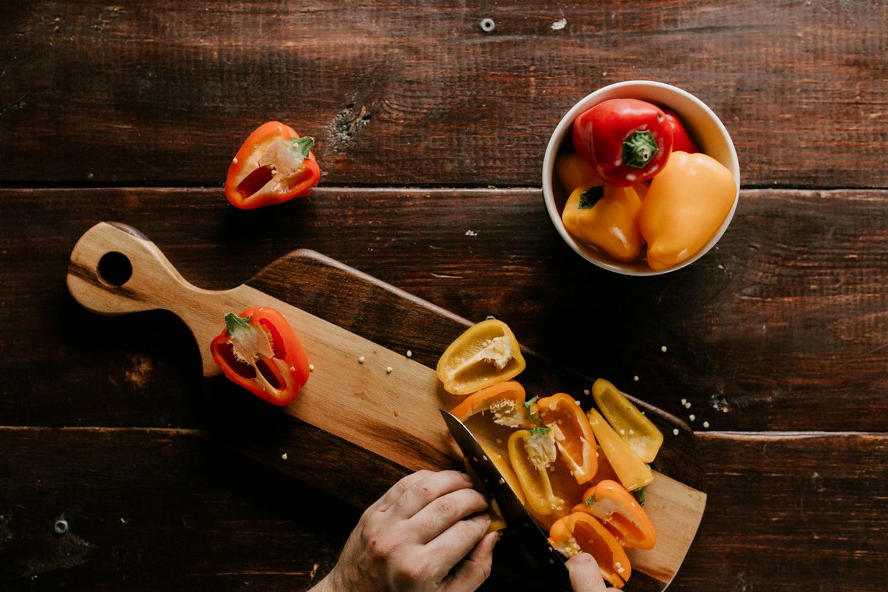 eating more plants — colorful fresh vegetables arranged on wooden cutting board