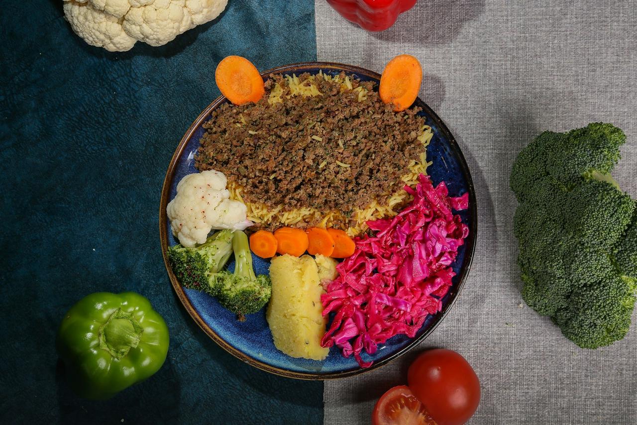 plant-forward meals kids — colorful vegetable plate with happy child