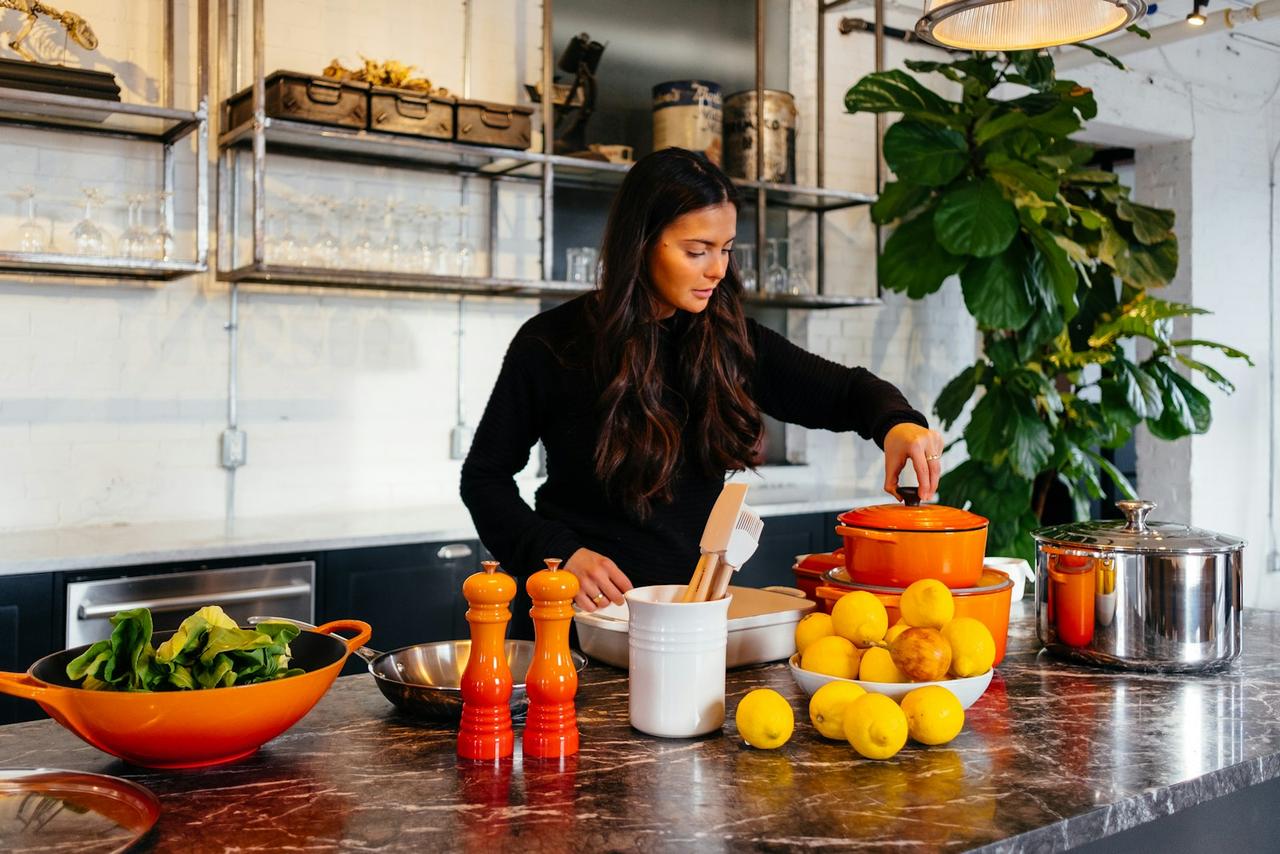 simplify healthy eating — woman preparing a quick plant-forward meal in a bright kitchen