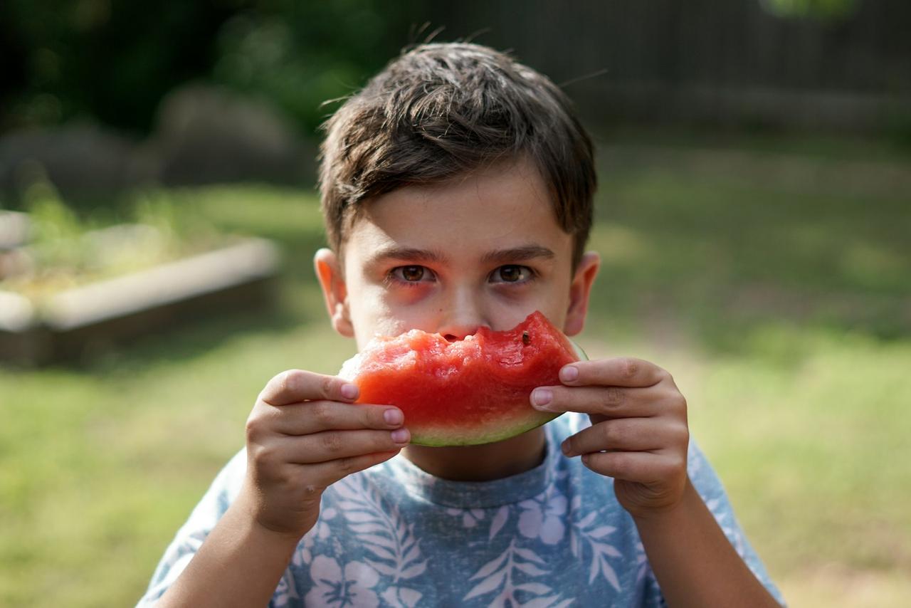 transition family to plant-based meals — child enjoying vegetables